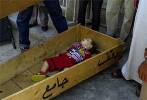 Mohammed Saleem, age 18 months, lies in a coffin in a Sadr City morgue Sunday June 6, 2004 after he and four other members of his family were killed Saturday night when U.S. forces opened fire hitting the vehicle in which they were traveling, according to the family.(AP Photo/Karim Kadim)