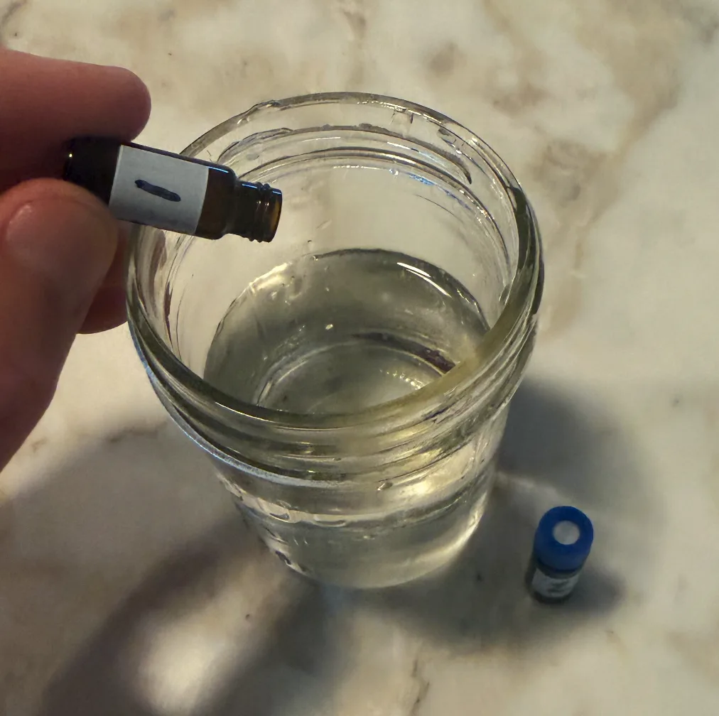 Adding liquid from a vial to a water sample