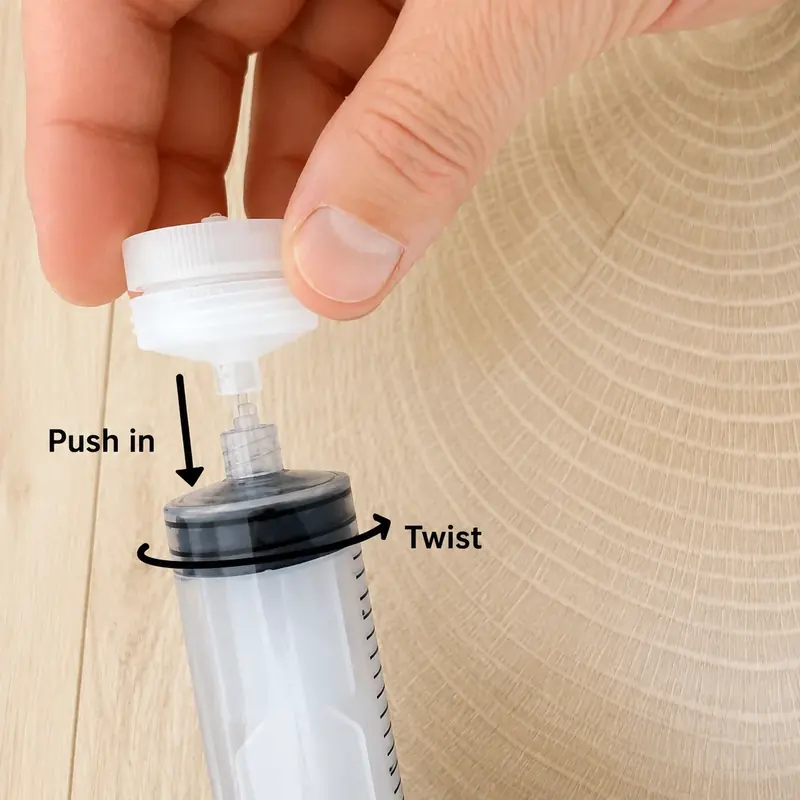 Twisting the assembled filter holder onto the syringe tip