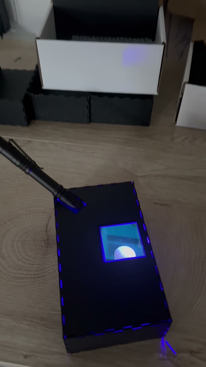 Imaging box with blue flashlight shining through the sample window