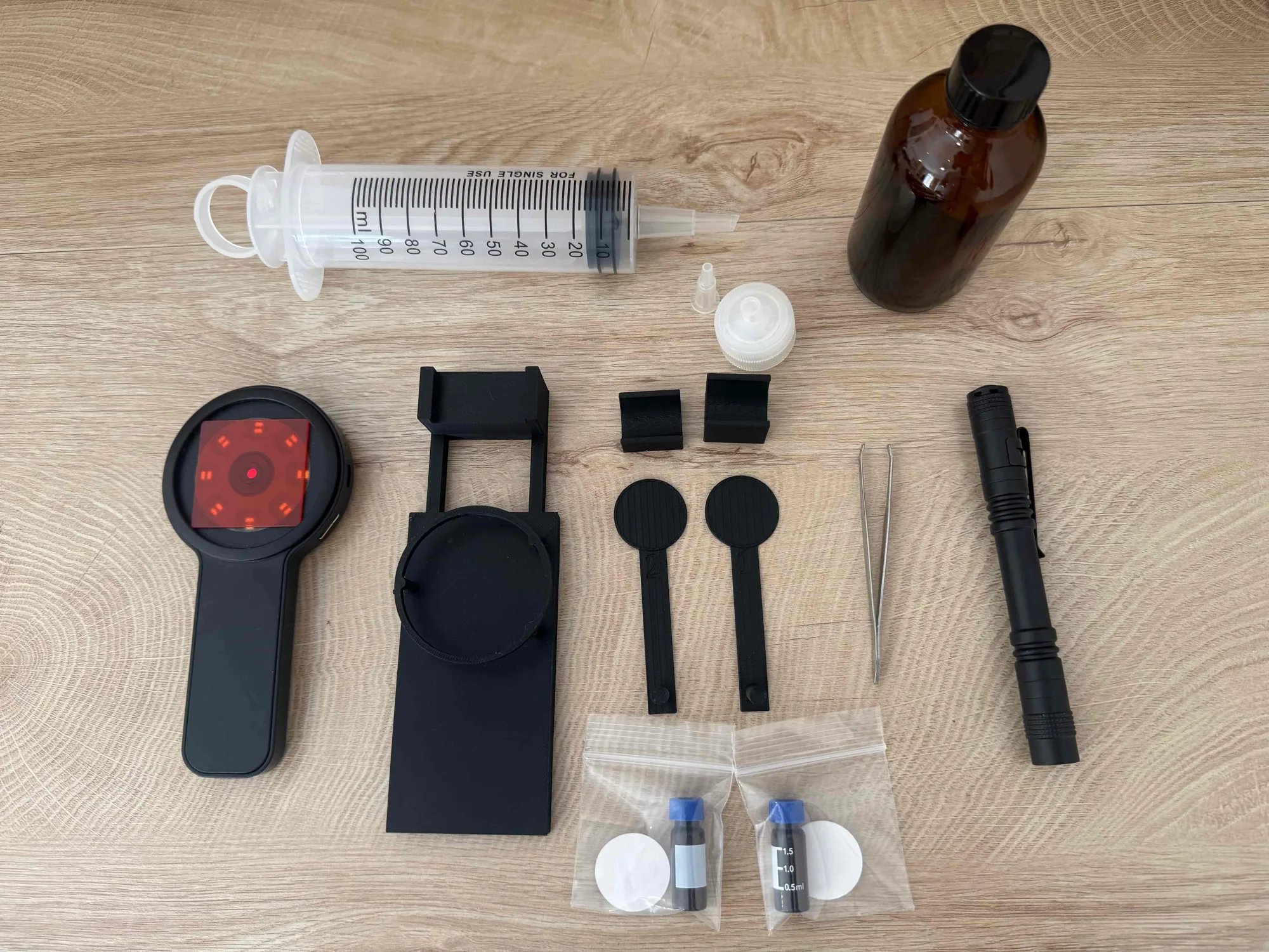 The Water Test kit contents: digital microscope, phone stand, syringe, syringe filters, and staining vials