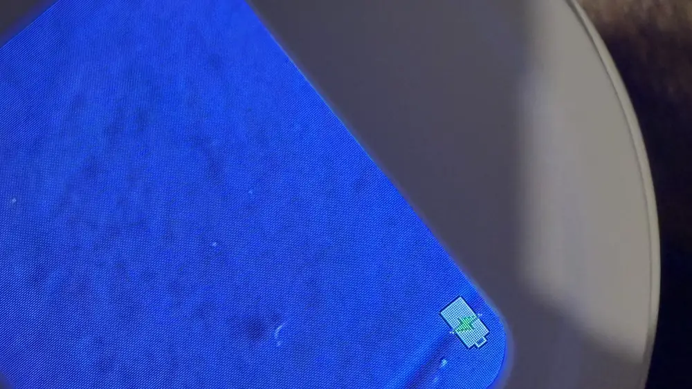A couple of faint bright points low on the filter membrane