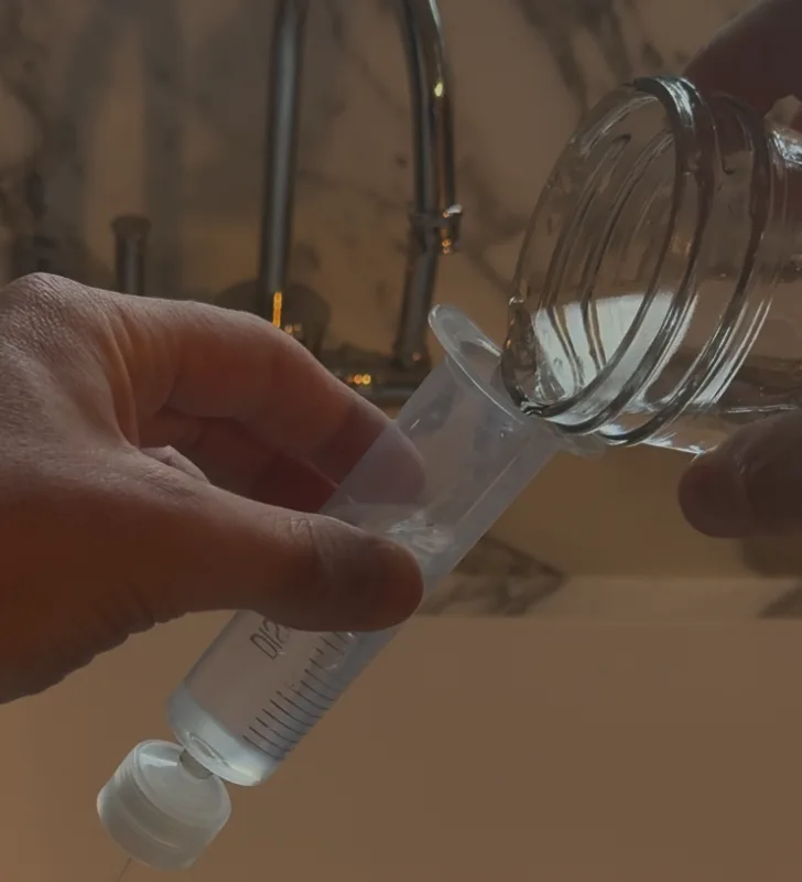 Pouring prepared water into the syringe