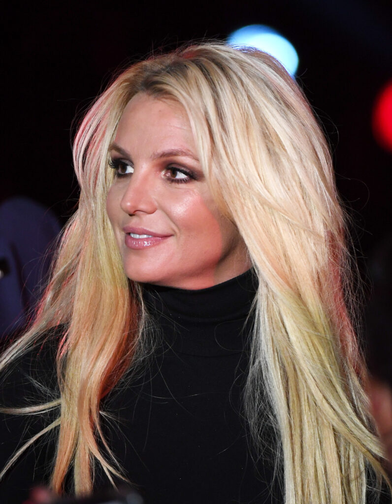 A 2018 photo of Britney Spears sporting thick blonde hair and looking to the side.