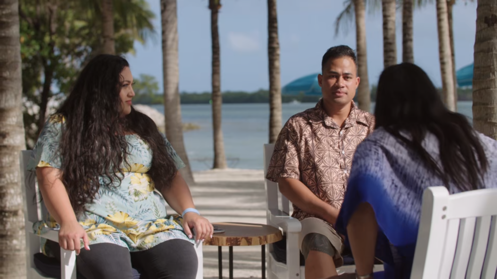 Kalani Faagata and Asuelu Pulaa sit on the beach across from a pair of therapists.