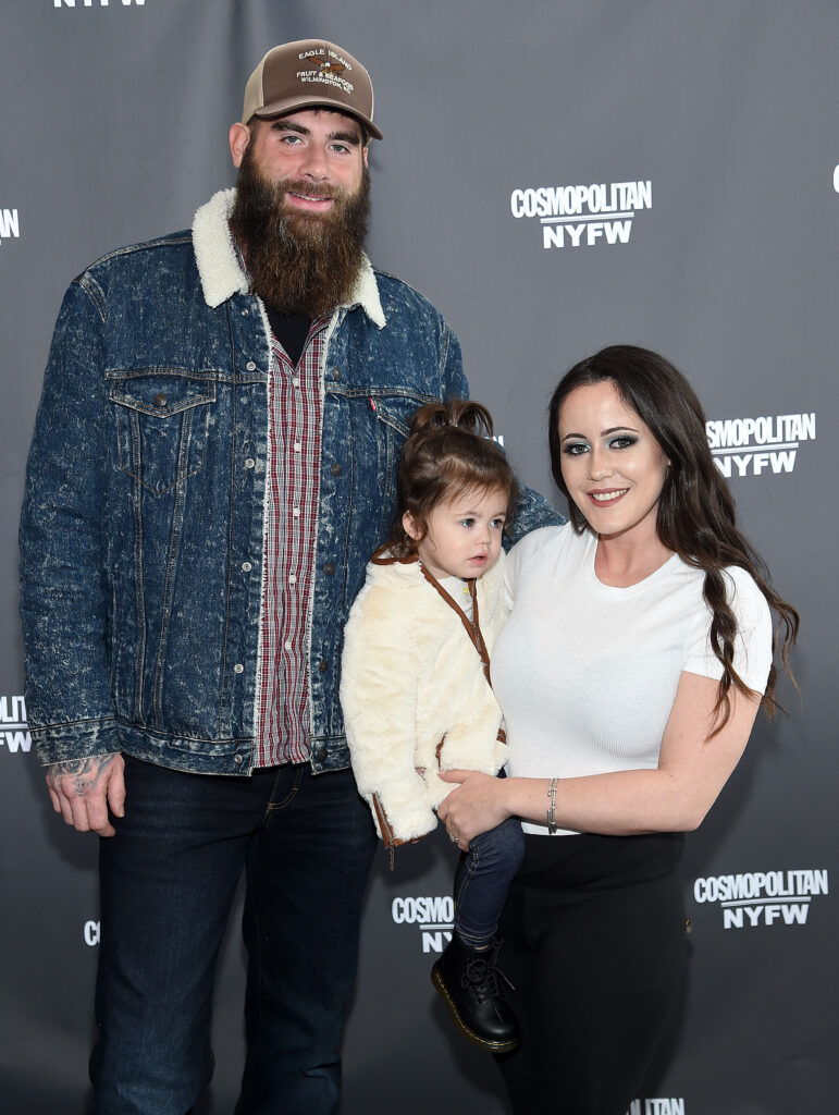 Jenelle Evans holds daughter Ensley and poses on the red carpet alongside David Eason at a NY Fashion Week event.