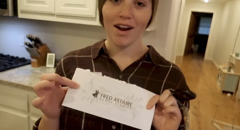 Joy-Anna Duggar shows off a gift from her husband: a gift certificate to the Fred Astaire dance school