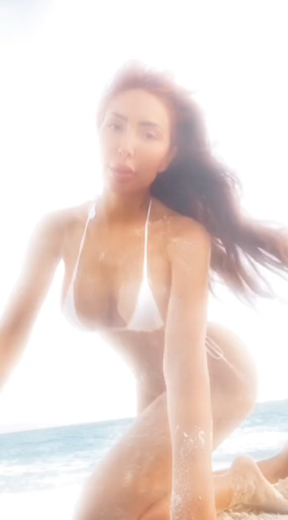 Farrah Abraham wears a white bikini and appears through a filter.