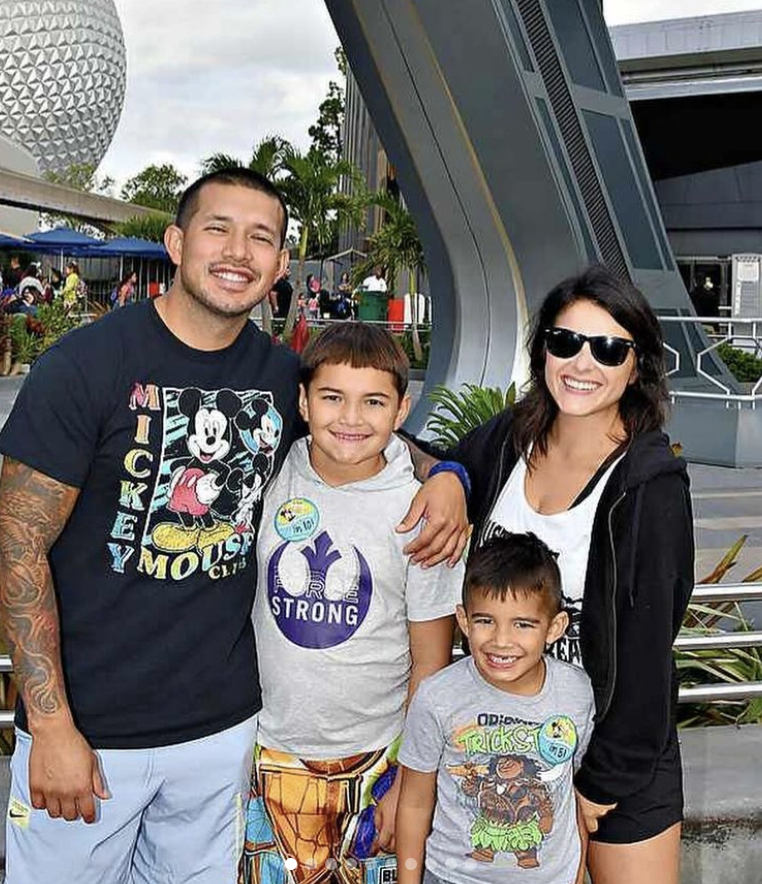 Javi and Lauren pose with their son Elijah and his son Lincoln at Disney World.