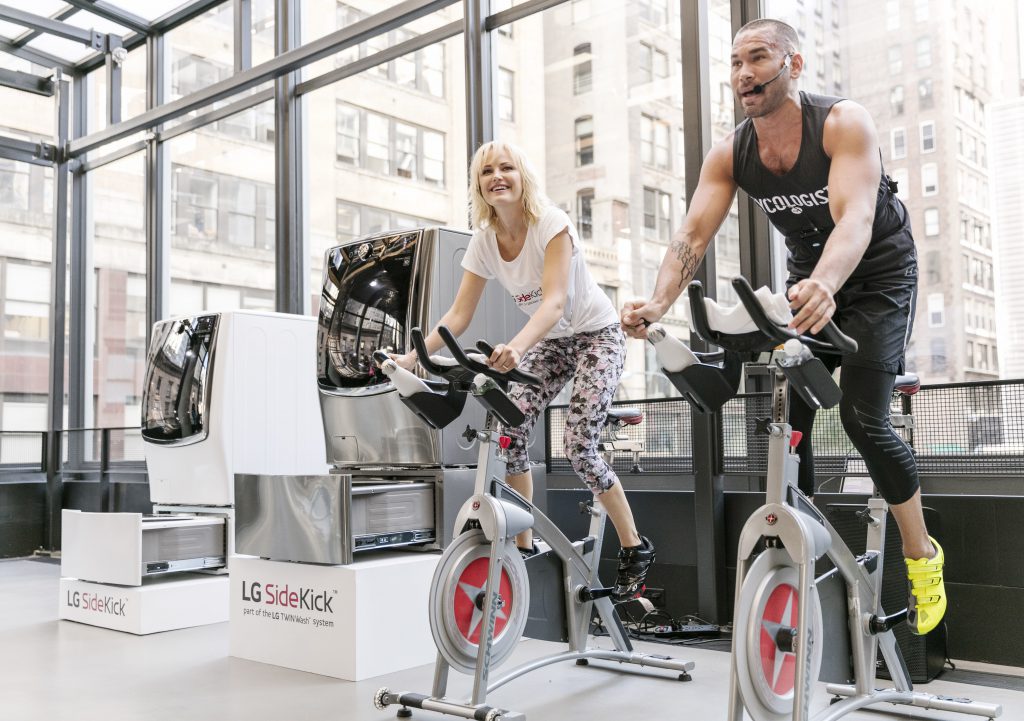 Malin Akerman, left, star of Showtime’s hit show Billions, spins tirelessly alongside Cyc Fitness founder Keoni Hudoba at LG’s ‘Fit-Fashion’ event Wednesday, June 29, 2016 in New York. A celebrity fitness enthusiast, Malin uses the LG SideKick to protect her favorite workout gear with its Active Wear-specific cycle. Photo by LG.