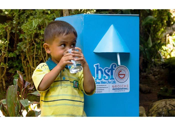GROSCHE Safe Water Project: Young boy drinking clean water from a Grosche Biosand filter