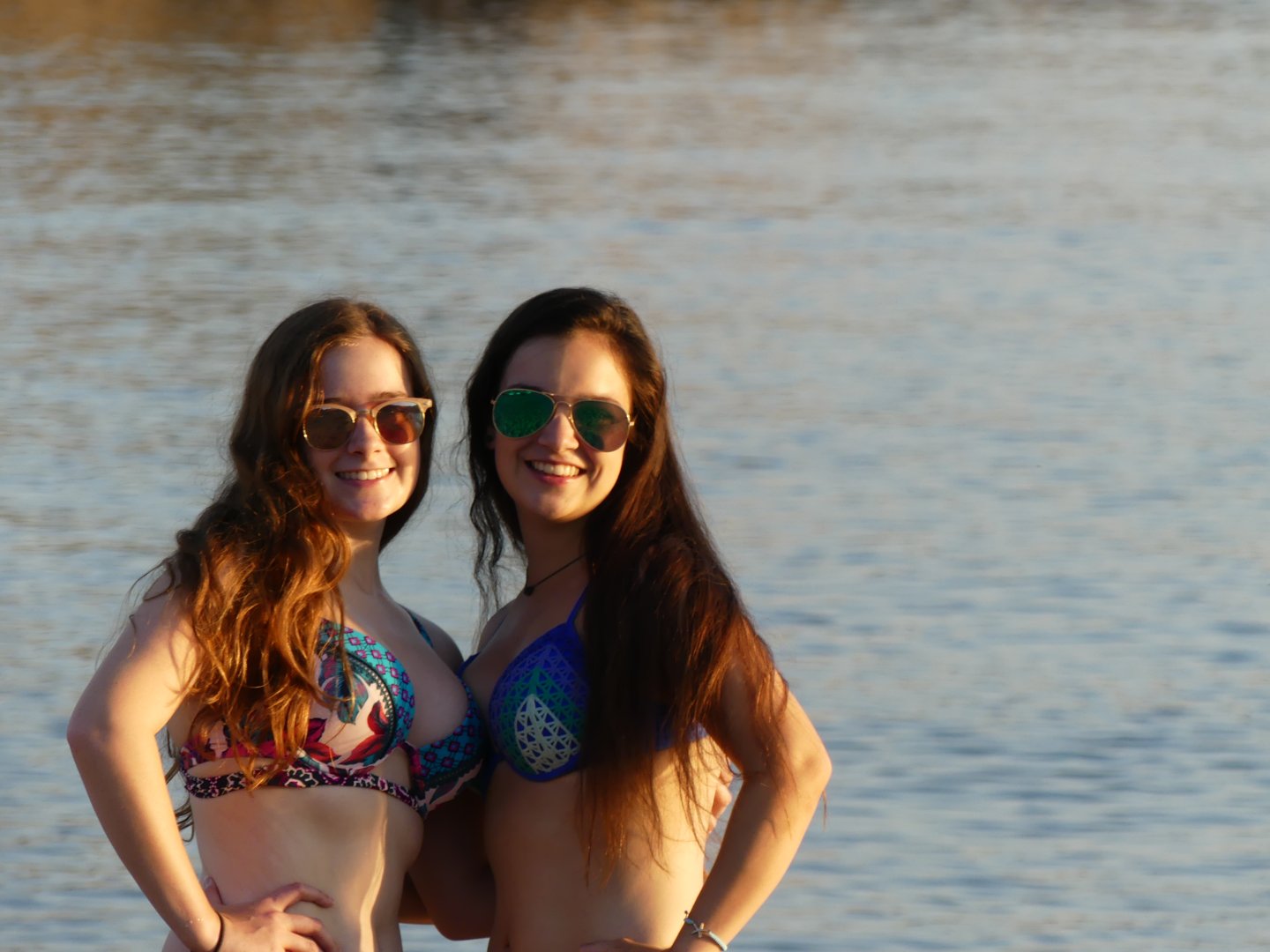 Madeline Grice and Emily Grice in bikini swimsuit on the beach on Crete, Greece in the sunset light. Europe, 2019