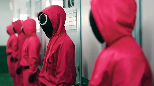 Squid Game Pink Guard Standing In Line wallpaper on Pixipics