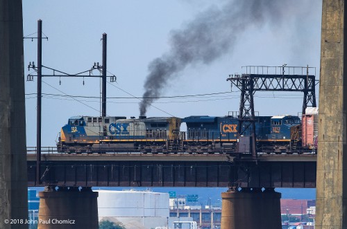 Both CSX liveries lead an Autorack train over the Upper Bay Draw, into Doremus Avenue.