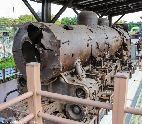 This steam engine was bombed during, the Korean War, and abandoned on the DMZ, until 2004, when it was removed and put on display, in Panmunjom. During the war, the steamer collected over 1,000 bullet holes and shrapnel holes.