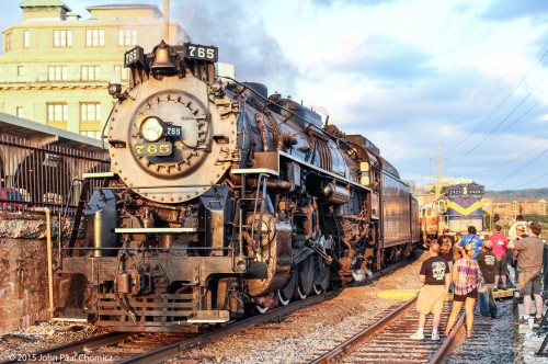 A crowd of people greet the Nickel Plate #: 765, as it passes the old Lackawanna Station, on its way to Steamtown.