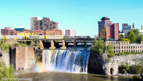 Two Bright Future units lead an autorack train over the Genesee River Falls, in downtown Rochester, as they head westbound on the Chicago Line.