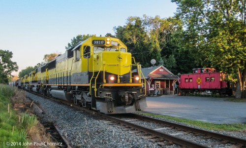 SU-99 passes the old station and caboose on the former Lehigh & Hudson River mainline, in Sugarloaf, NY.