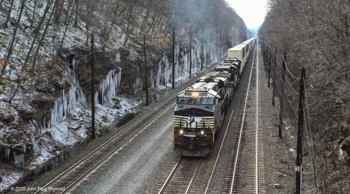 Icicles line the walls of this rock cut, creating a beautiful backdrop for this eastbound intermodal train, at Cassandra, PA.