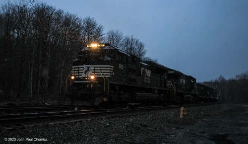 It's now dusk as the headlights on the eastbound mixed freight, that we saw in Johnstown, light the way as it passes through Lilly, PA.