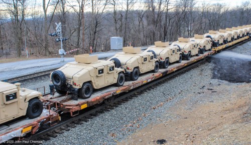 This is a lesson on why you shouldn't lower your camera until the entire train passes. You just never know what you'll find on a train. In this case, the surprise was a long string of flat cars loaded with M1151 HMMWV "Humvees".