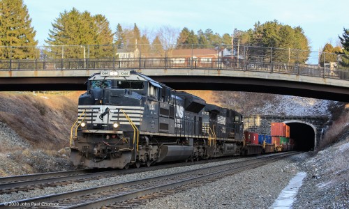 A westbound intermodal train blasts out of the Gallizten Tunnel.