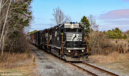 The Beesley's Point Secondary is a rail line that runs through the New Jersey Pine Barrens. Besides the Pine Barrens notoriety for being the residence of the Jersey Devil, they are also known for their beauty. Here the Camden local approaches a crossing in Winslow Township, NJ.