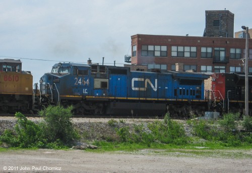 The CN #: 2464 "Blue Devil" unit is the middle unit on a train, near Cermak Road, in Chicago, Illinois.