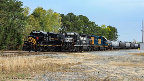 Winchester and Western passes the Conrail power, in Millville Yard, after it stopped to pick up the train orders in the yard office.