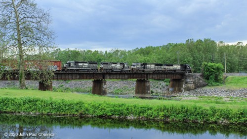 A westbound freight pauses on the Lehigh River Bridge, at west end, as it waits to double up to the rest of its train, at Canal Park, in Allentown, PA.