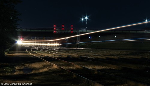 Does this signify a communist revolution? No, it just means all stop signals for the westbounds as an eastbound intermodal train speeds through Bethlehem, PA, in this nocturnal scene that would normally be blocked by PB&NE interchange cars.