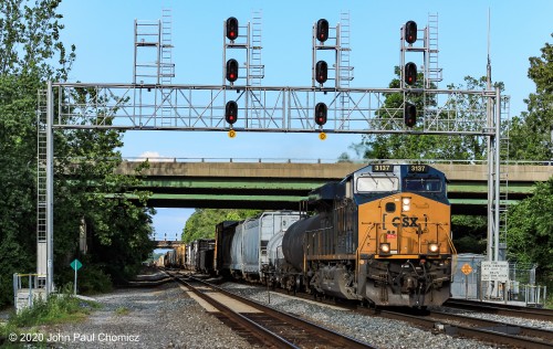 A  beautifully lit, CSX southbound mixed freight passes under the signal bridge, at St. Denis.