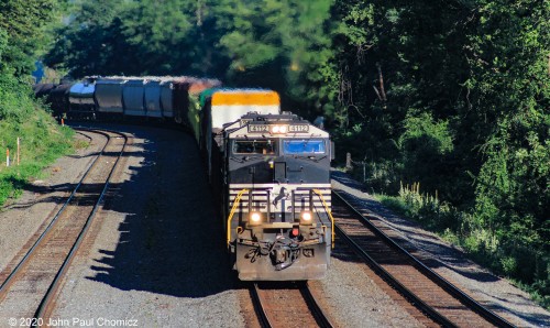 A Manifest Freight  Train heads east, at CP Banks, on a sultry Saturday morning.