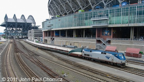 The southbound Amtrak Cascades passes, then Safeco Field, and Century Link Stadium after departing from Seattle King Street Station.