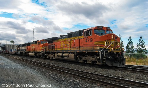 Pumpkins and, even a unit wearing its original cream and green BN scheme, lead this intermodal train in Seattle, Washington.