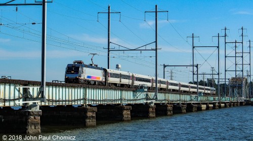 A North Jersey Coast Line crosses the Raritan Bay Bridge into Perth Amboy, NJ.