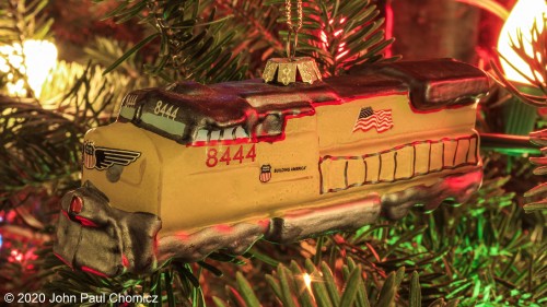 This past week has been extremely busy for me, so I wasn't able to get a nice Christmas themed photo to post. So, instead of going out and about searching, I looked no further than my living room and found a suitable subject for posting. Union Pacific #: 8444 hanging gracefully from my Christmas Tree. MERRY CHRISTMAS to all you fellow Trainnutz! Hopefully, this Christmas brings some light to an otherwise dismal year.