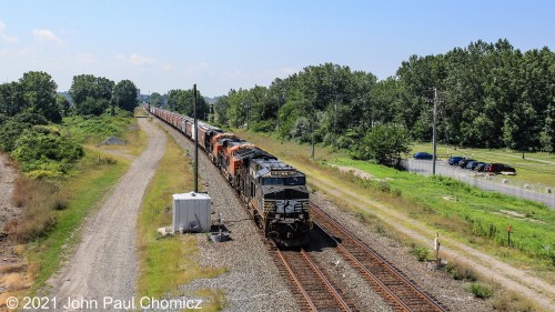 With the colorful BNSF units giving away its western origin, an eastbound unit grain train skirts through Whiskey Island in Cleveland, OH.