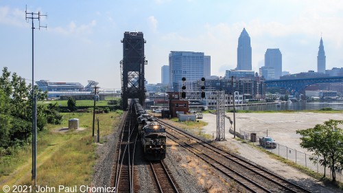 Another day at this location and I was determined to get a westbound with a well-lit backdrop. The first action, that morning, was of a loaded westbound coal train crossing the Cuyahoga River on the famous Chicago Line Drawbridge.