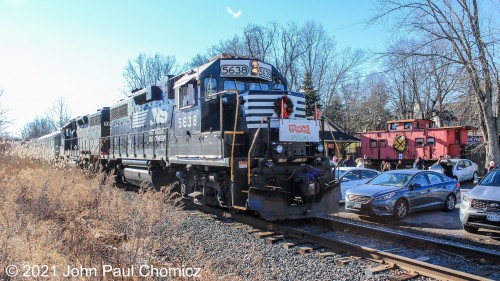 The two leading units of the Toys for Tots Train pass the old caboose as they pull out of Sugar Loaf, NY. It was a bit of a change to see NS units as the last time I was here was for an SU-99 chase. At that time, it was during a long evening of the summer, and it was the Yellowjackets of the Susie Q in the lead. The photo was previously uploaded to this website.