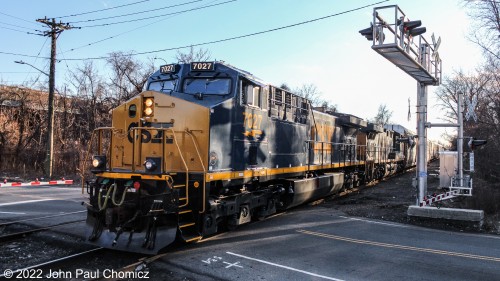 After making a brief stop to pick up its conductor, this northbound Q-Train crawls across the crossing in Jersey City, NJ.