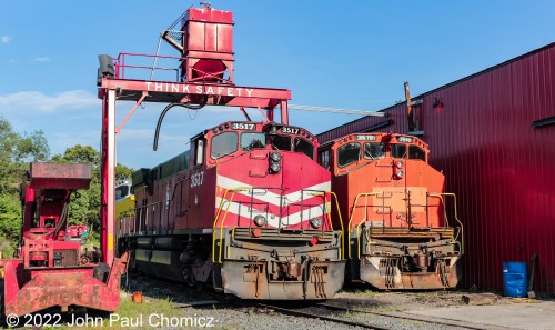 After arriving a bit late to catch them returning from action, I got a photo of these two SRNJ units sitting under the sand-tower with the big slogan, "Think Safety". As per my discussion with the crew, the only two operating units of this short line are the 3517 and the 800, behind it. The 3519, on the right, is out of service along with all the other units at their base in Winslow Junction, NJ. Photo taken in 2019.