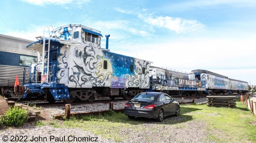 The entire consist of the Sky Railway excursion train sits at the Santa Fe Depot in Santa Fe, NM. The railway is relatively new and is painted in celestially themed liveries.