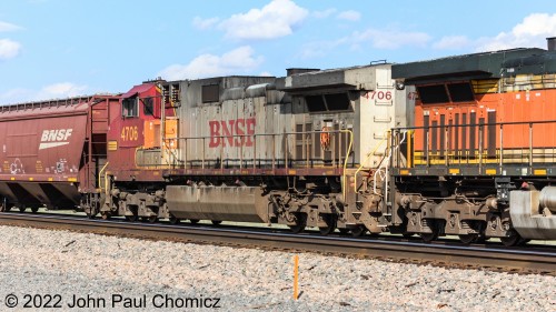 BNSF Warbonnet #: 4706 is the fourth unit in the westbound covered hopper train at Lucy, NM.