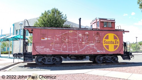 This ex-AT&SF caboose has a partial Santa Fe route map painted on its side. It's on display outside the Gallup Amtrak Station in Gallup, NM.