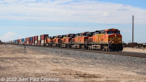 Unlike here in the east, out west, the rail traffic is steady, and you can get your fill of railfanning action in a few hours at one location. Here, another multi-unit westbound intermodal train passes through the Belen, NM suburb of Rio Grande Estates.