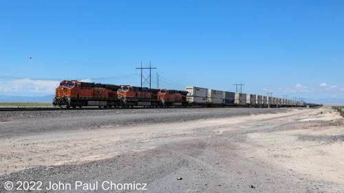 An eastbound BNSF doublestack train crosses Route #: 47 a little further out from Belen, NM.