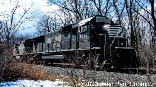 After the train crossed River Road, it paused long enough for me to photograph the trailing unit, ex-Conrail SD70 #: 2577. Back then, they were still quite common but, as of posting this photo, they're all gone from NS. This one in particular was sold to ProgressRail in 02/20. This was one of those photographs where the I felt the lighting wasn't  good enough and it was behind too many bushes to post, at first.