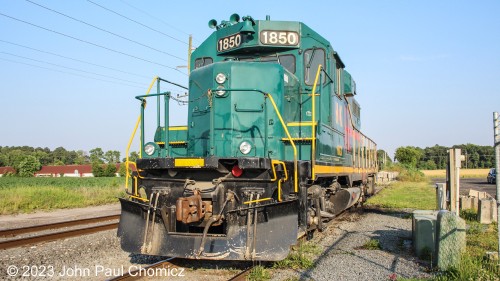 Dagsboro Stone Supply, in Dagsboro, Delaware, is a crushed stone supplier that receives unit stone trains from the NS. The #: 1850 is a GP11 that provides switching of the stone hopper cars in the plant yard. Here, the unit is parked at an angle that makes it difficult to photograph the well-lit front side of the unit.