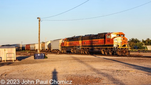 After all the UP action, I stopped at the BNSF yard and was lucky enough to catch this mixed freight as it crossed North 10th Street in Enid, OK. The lead unit is the BNSF #: 1402 an SD60M. It was built with a North American safety cab and became known as a, "Triclops", because the early models of this unit featured three front windows in the cab. The later models would only have double-sloped window panes.